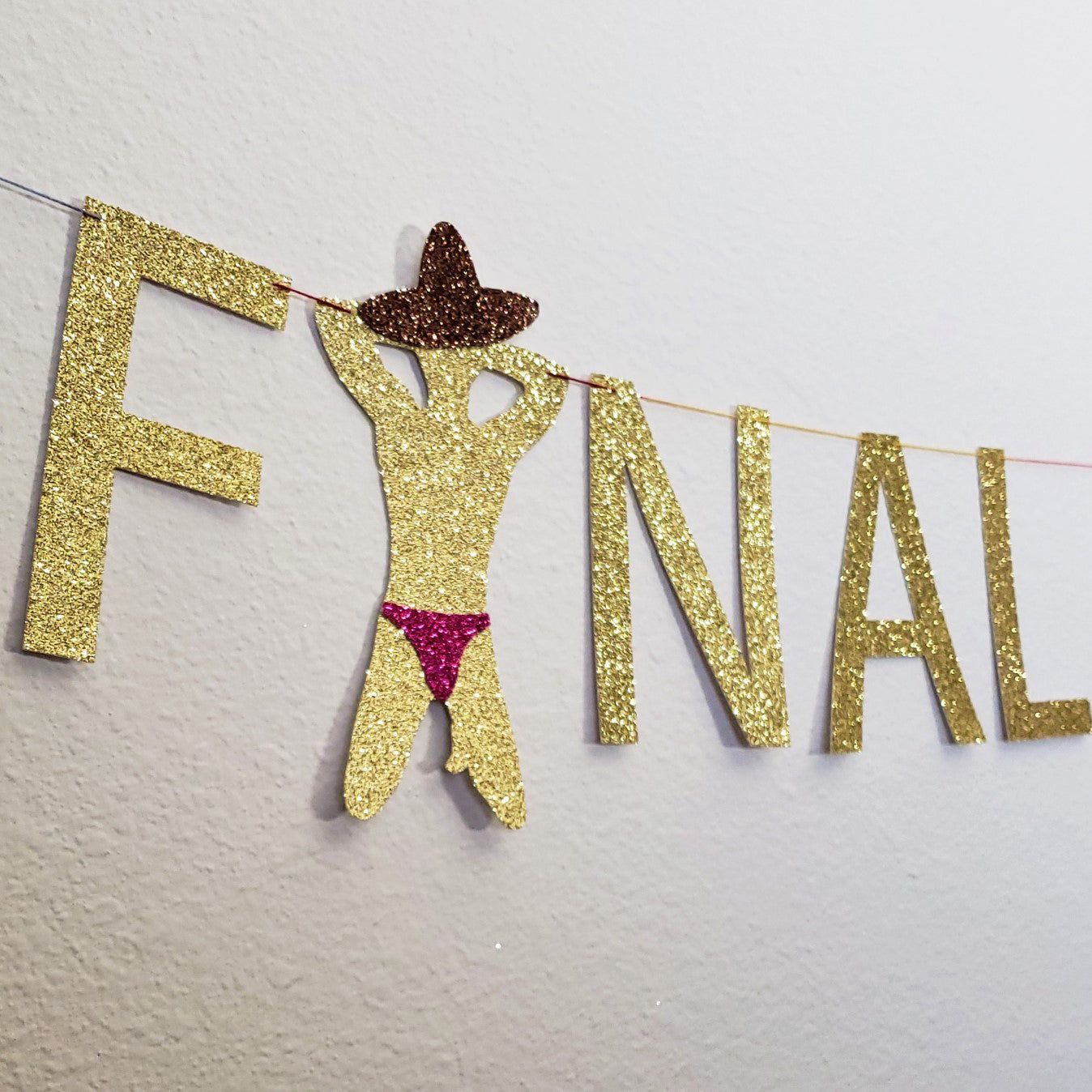 close up of male stripper banner wearing glitter brown sombrero and pink glitter thong